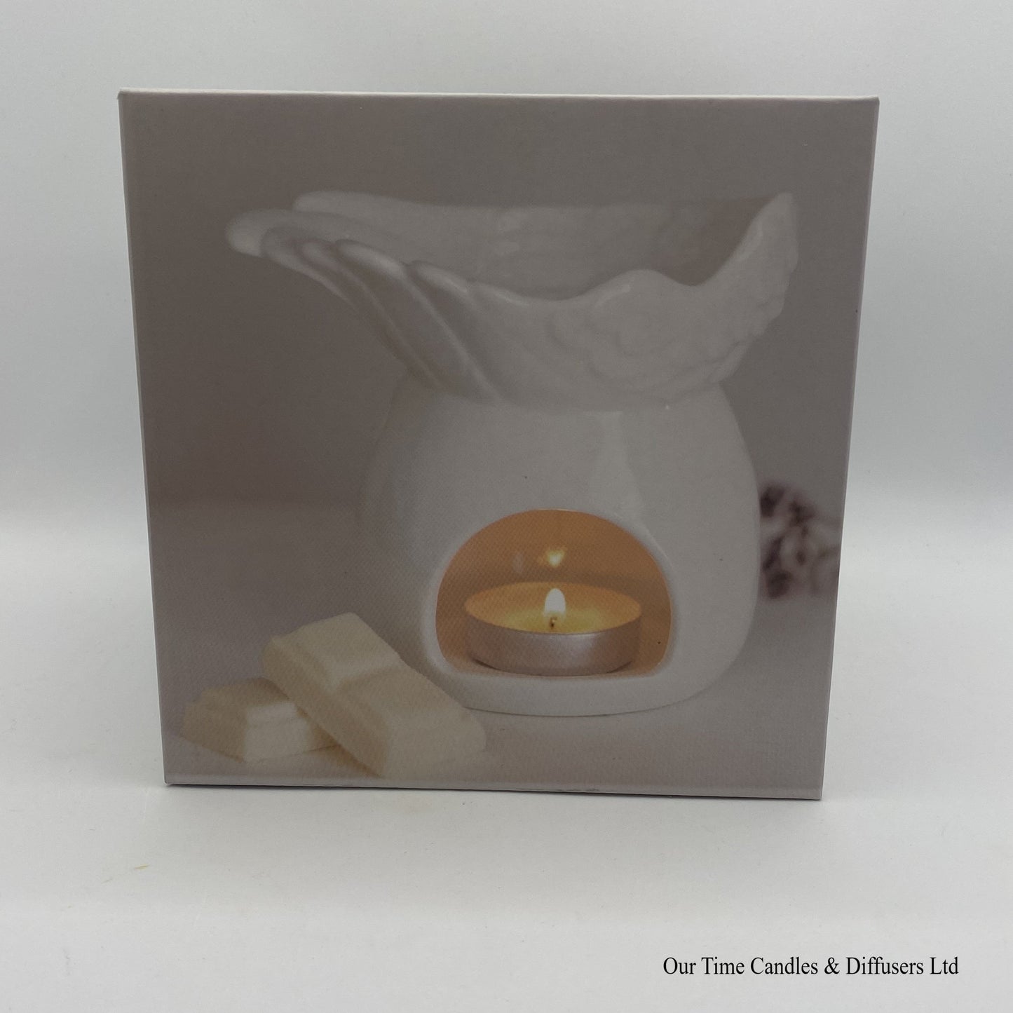 Gift box with front photo showing the angel wings wax Burner in use.